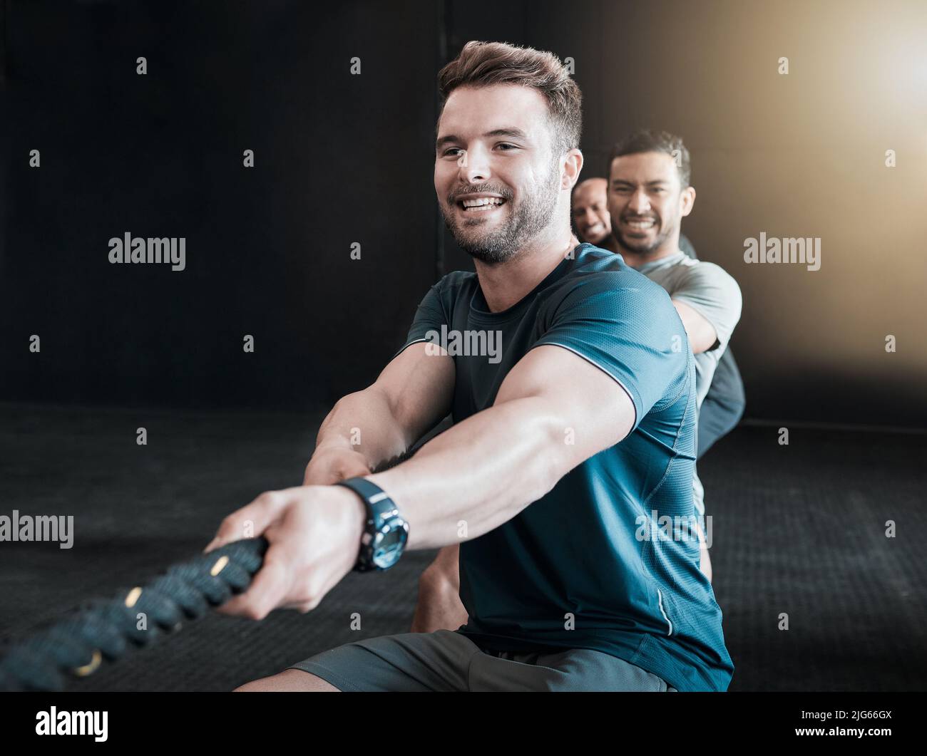 https://c8.alamy.com/comp/2JG66GX/its-all-in-the-name-of-fun-shot-of-a-group-of-gym-partners-pulling-a-rope-in-tug-of-war-together-2JG66GX.jpg