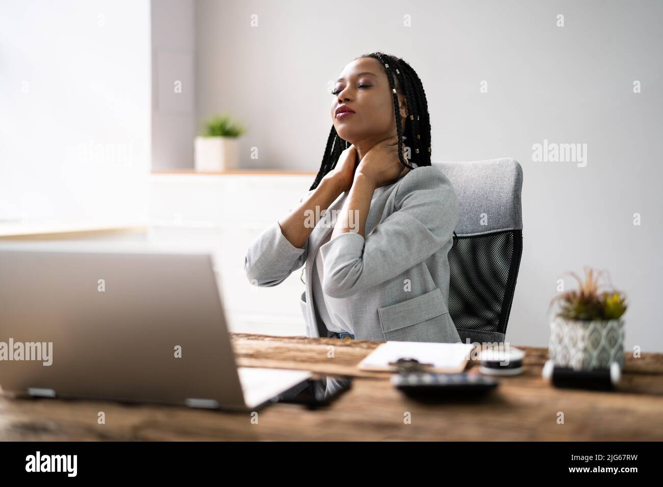 Woman With Bad Posture And Ergonomics While Sitting Stock Photo