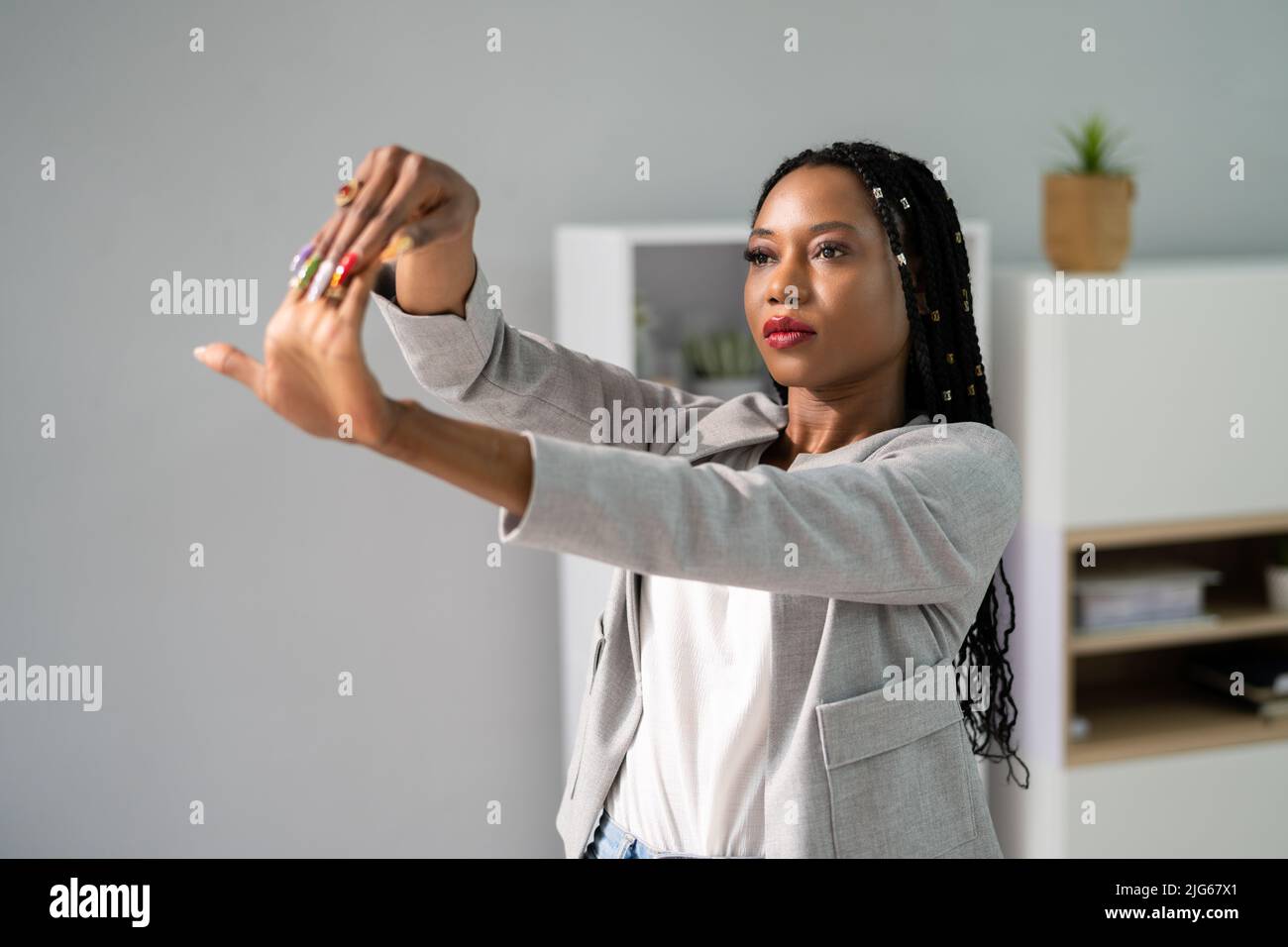 Stretch Exercise At Office Stretches While Sitting On Chair Stock Photo