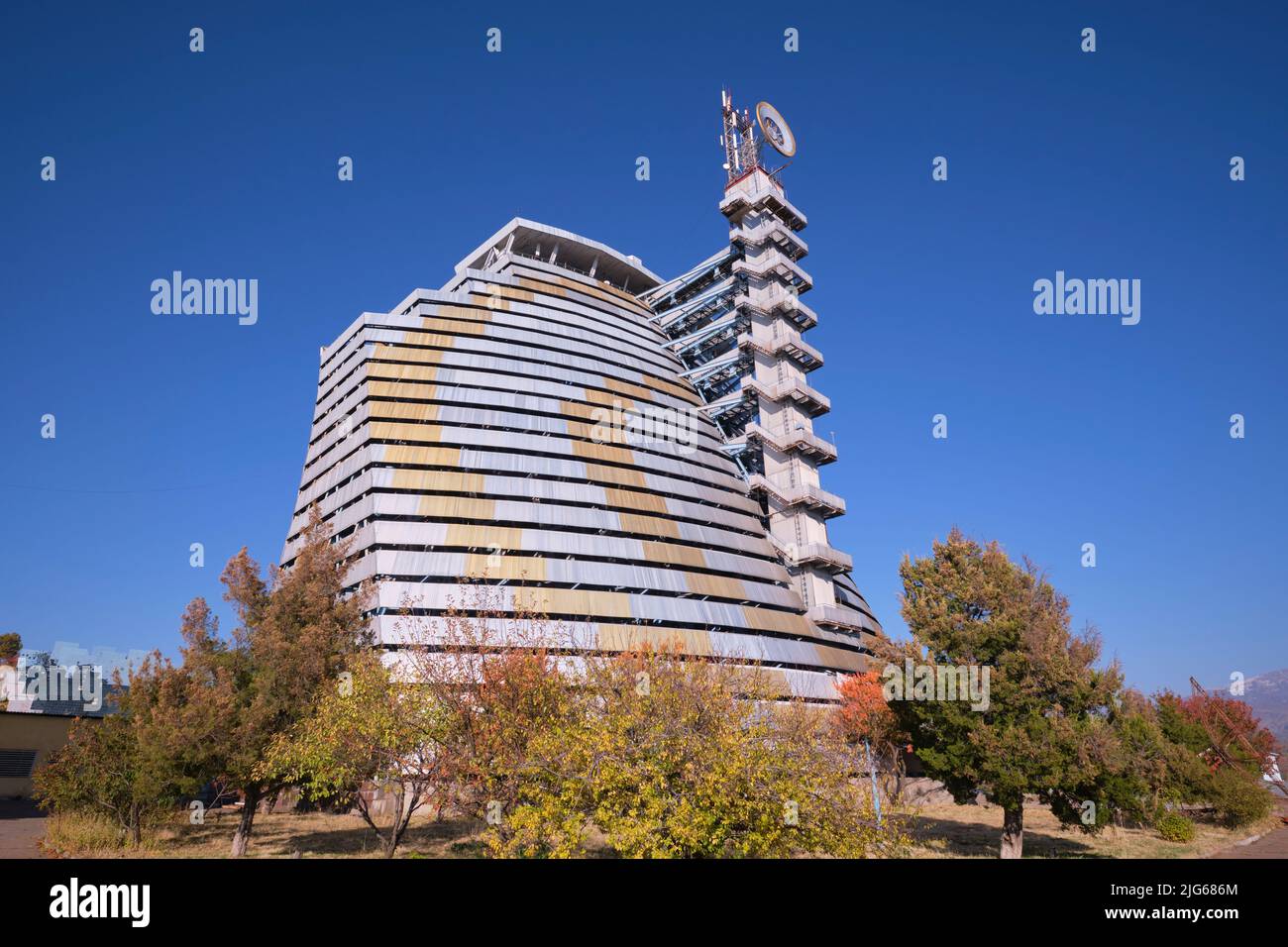 The silver banded curved back of the main reflector building at the Physics of the Sun Institute of Physics and Technology. In Parkent, near Tashkent, Stock Photo