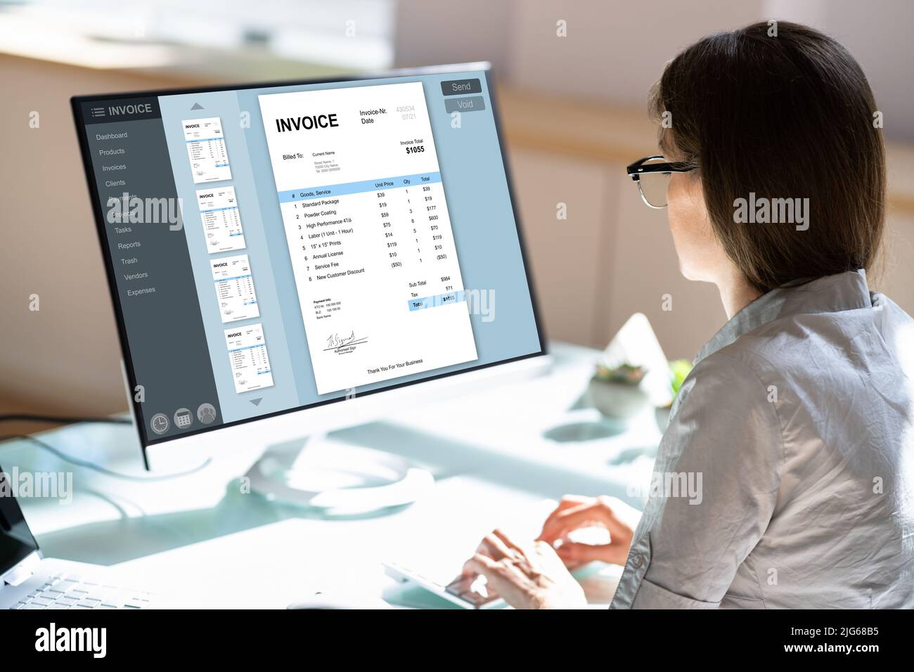 Chartered Professional Accountant Working With Invoice On Computer Stock Photo