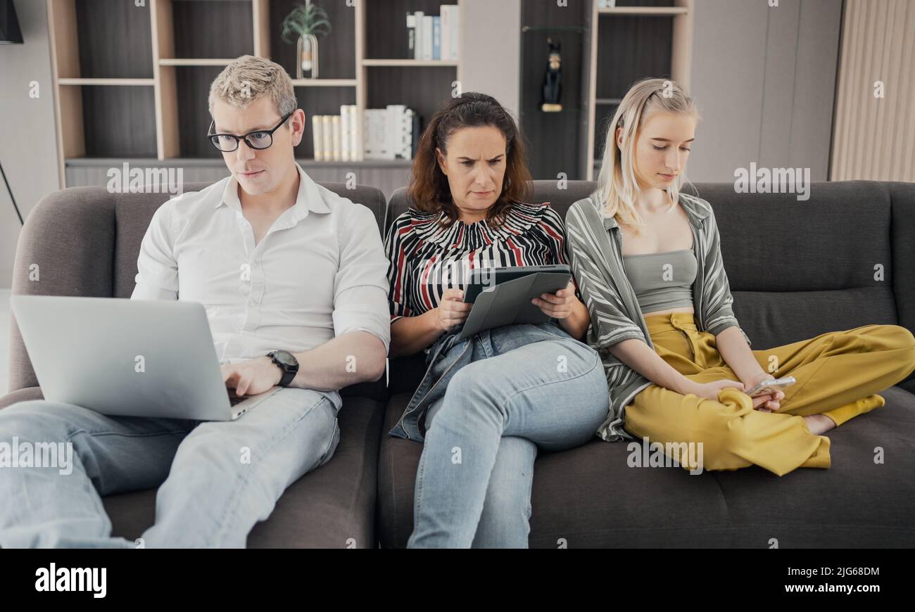 Gadgets addiction. Young caucasian of three holding and using different