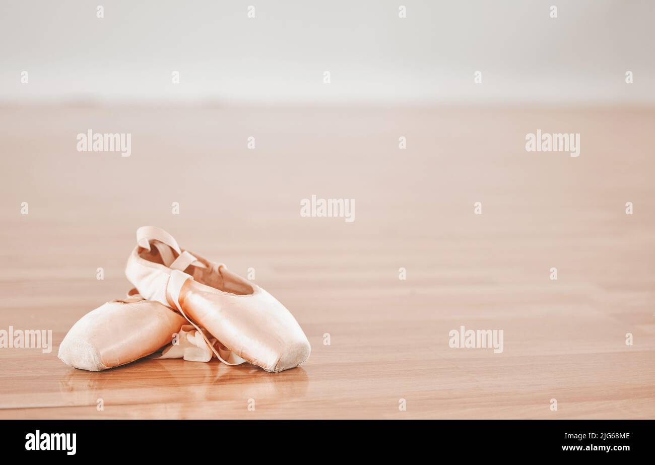 Sign up for ballet classes. Shot of a pair of ballet shoes in a dance studio. Stock Photo