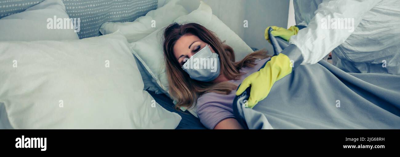 Doctors in bacteriological protective suits caring for a patient Stock Photo