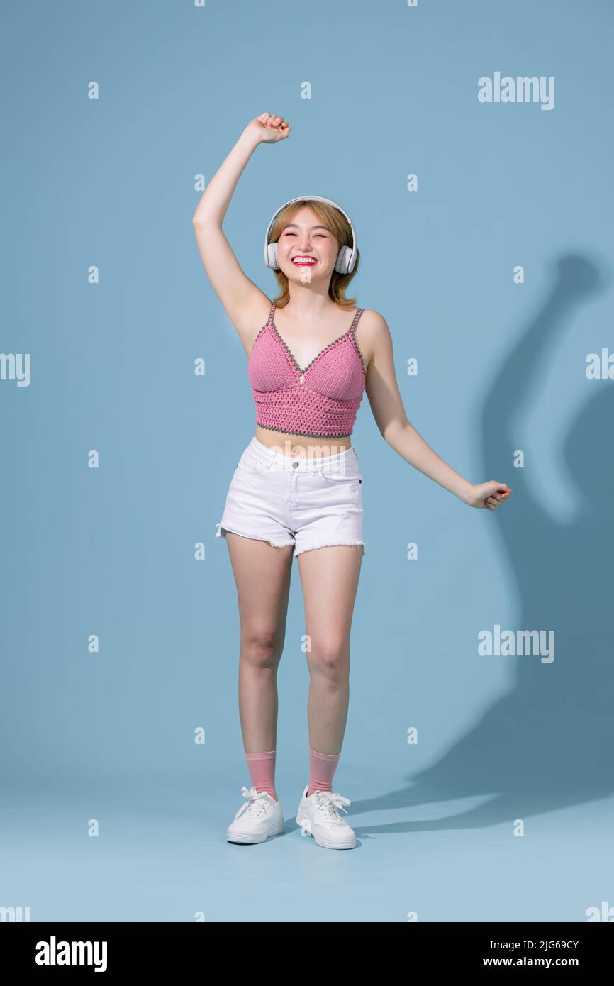 Full length body size view of pretty cheerful skinny girl listening different song rock dancing isolated on pink pastel color background Stock Photo