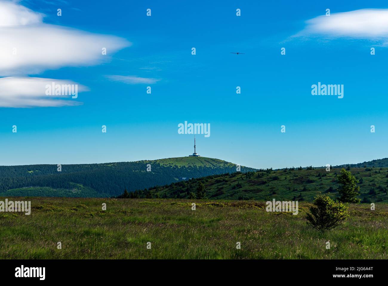 Praded hill with communication tower and airplane in sky above in Jeseniky mountains in Czech republic Stock Photo