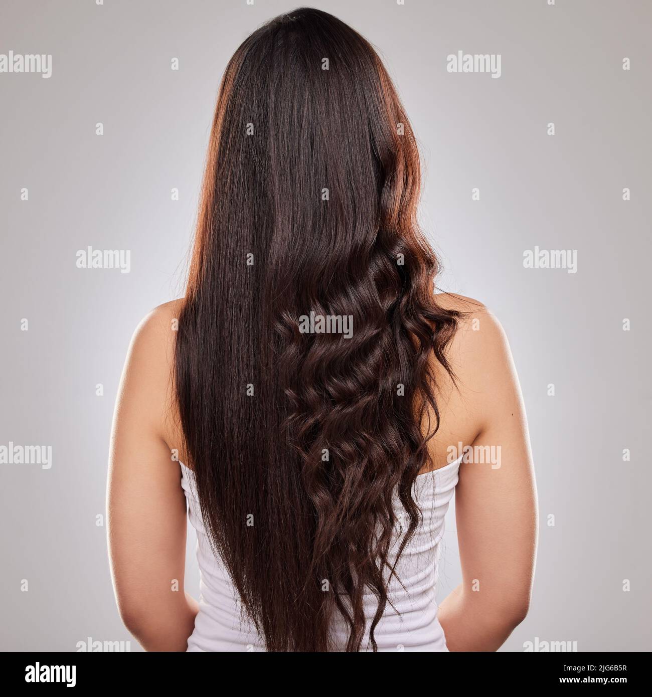 New hair means new horizons. Shot of a woman posing with half straightened and half curled hair. Stock Photo