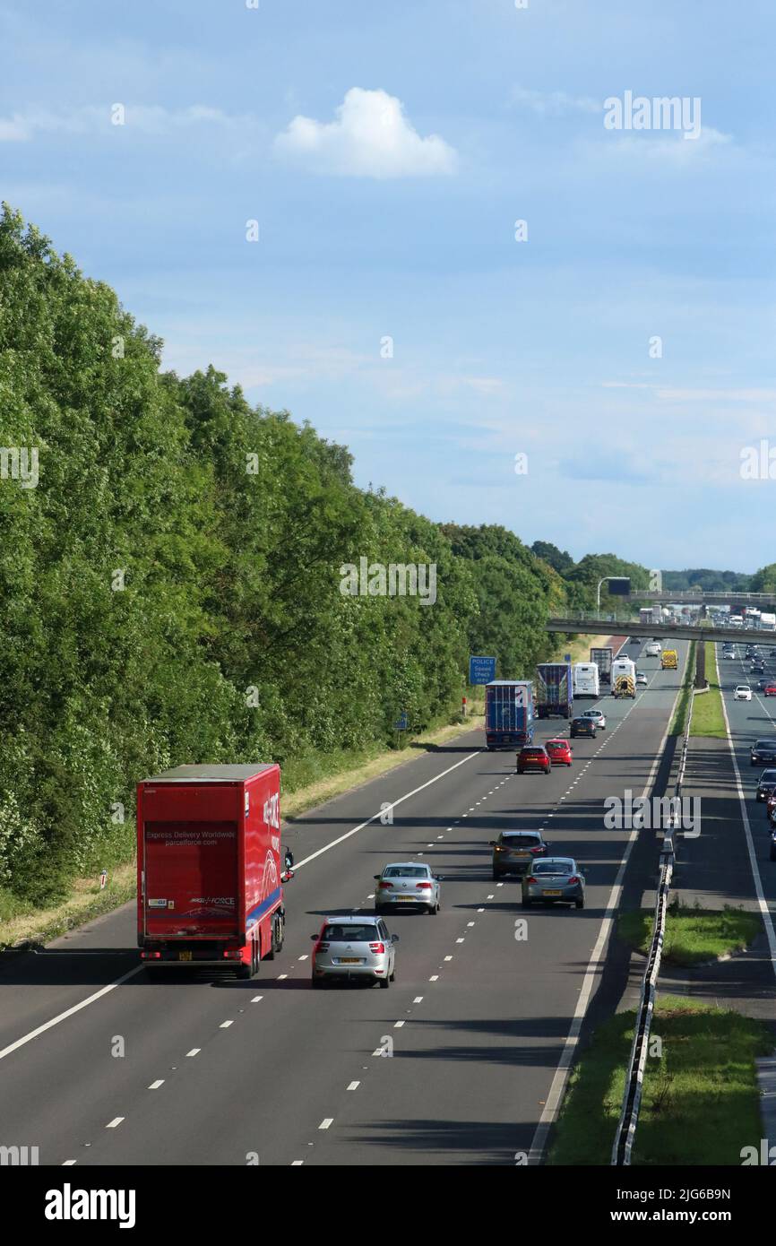 Traffic on southbound carriageway of three lane M6 motorway in countryside near Scorton in Lancashire on a sunny summer day in June 2022. Stock Photo