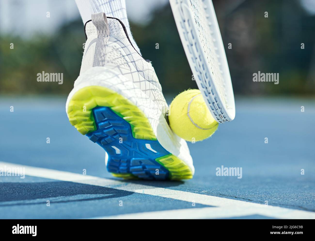 Only professionals pick up tennis balls this way. Cropped shot of an unrecognisable man using