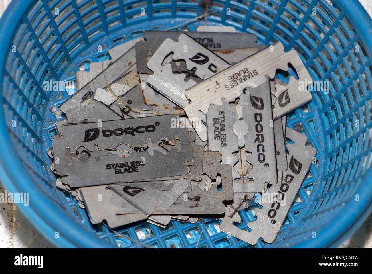 BANGKOK, THAILAND, MAY 01 2022, A pile of old razors in a plastic basket Stock Photo