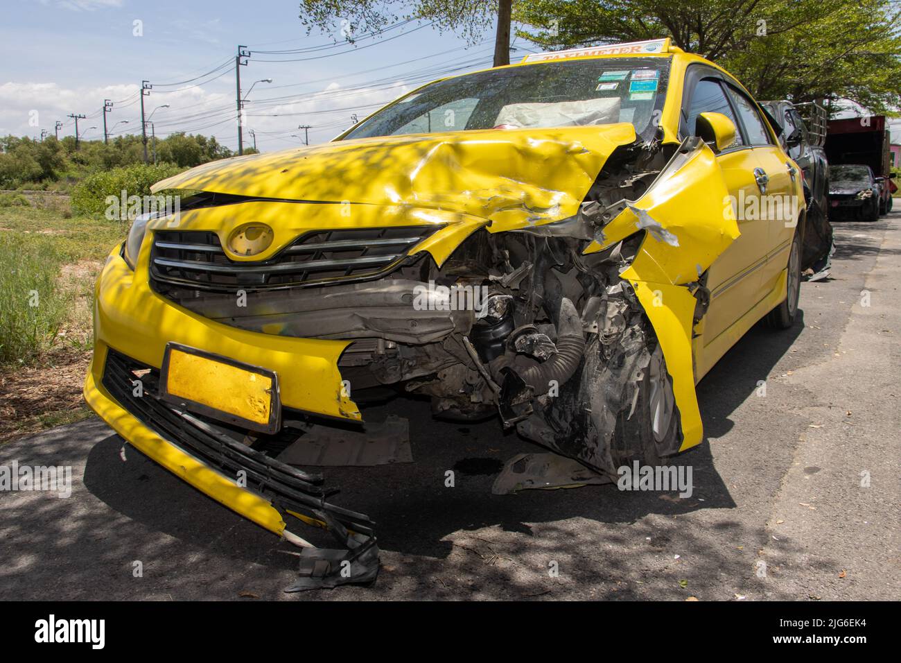 A taxi car damaged by a accident is stands on the street Stock Photo