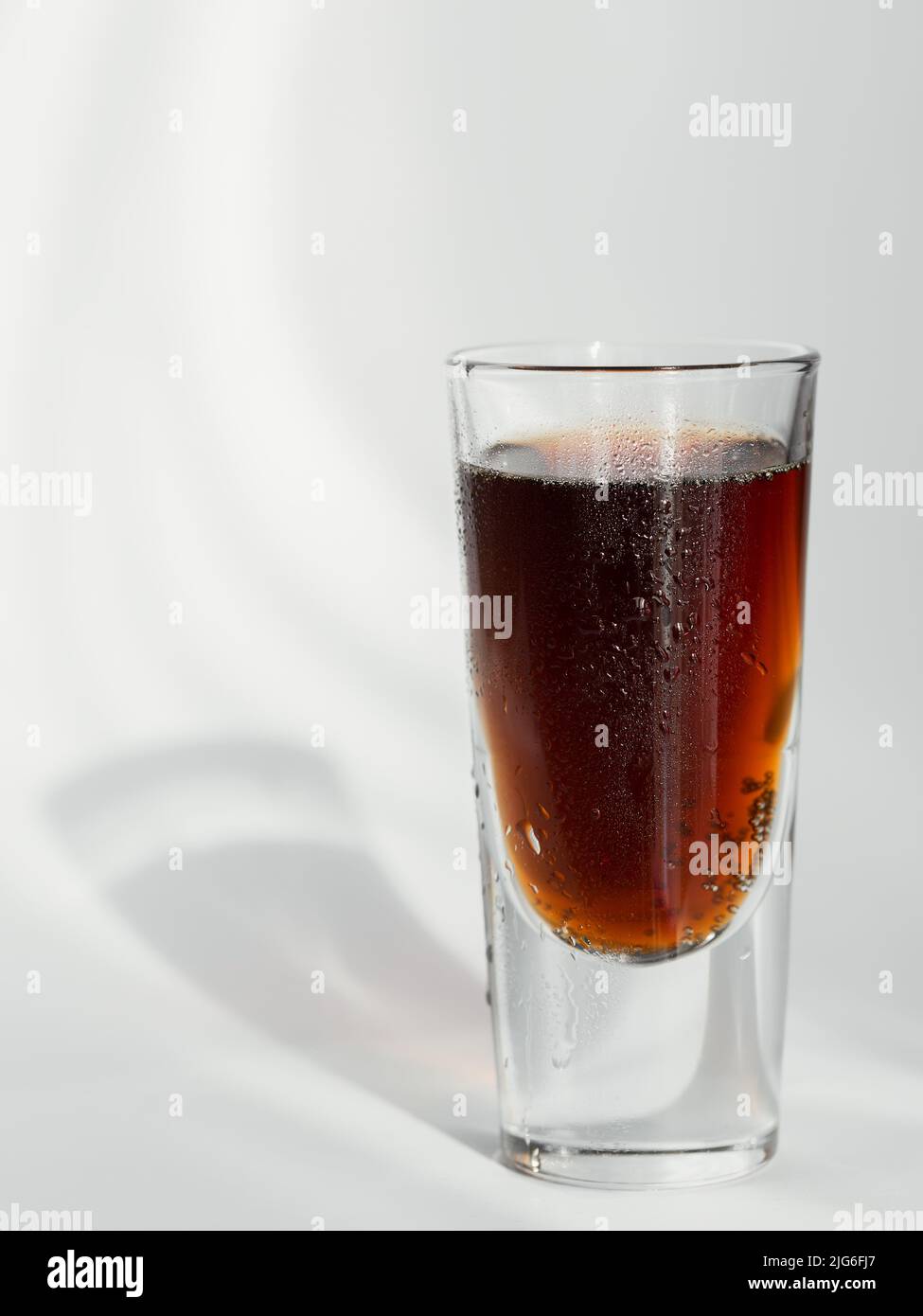 Glass of cola on white background Stock Photo - Alamy