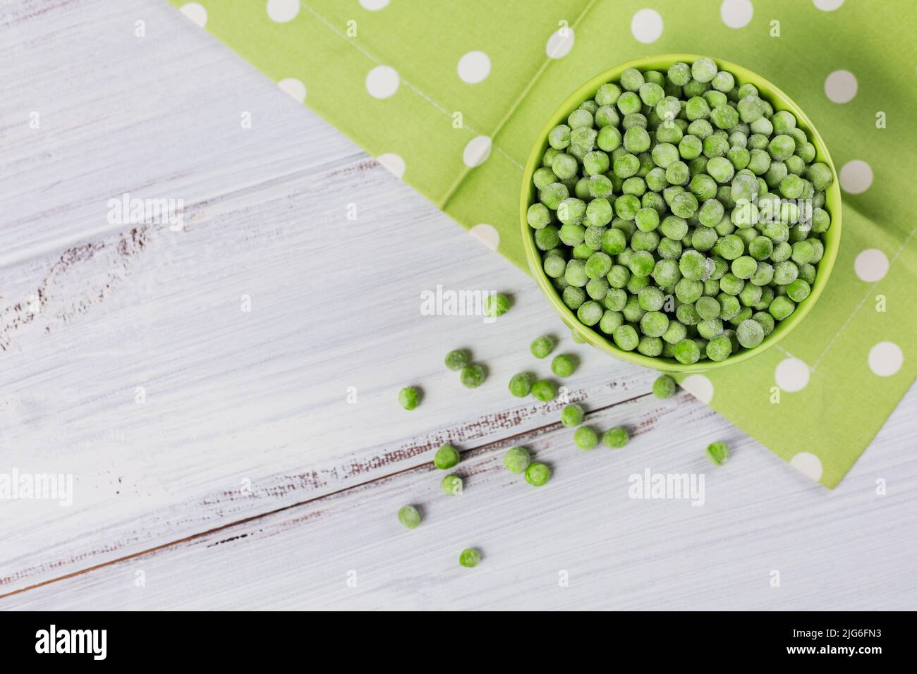 Top view composition with organic frozen vegetables on a white wooden background Stock Photo
