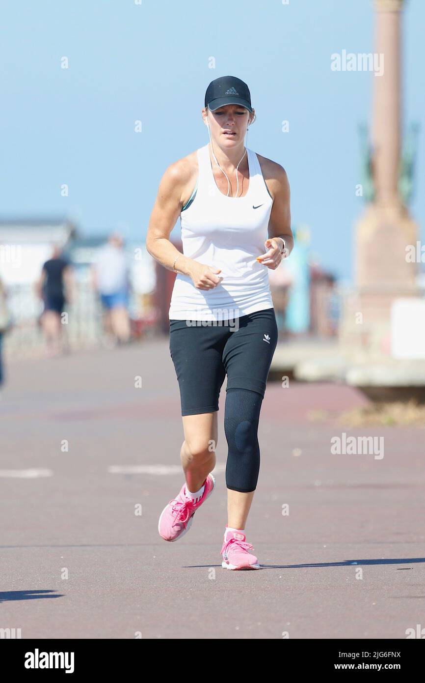 Hastings, East Sussex, UK. 08 Jul, 2022. UK Weather: Very hot and sunny at the seaside town of Hastings in East Sussex as Brits enjoy the very hot weather today and is expected to reach 29c in some parts of the UK. A jogger heading down the Hastings promenade. Photo Credit: Paul Lawrenson /Alamy Live News Stock Photo