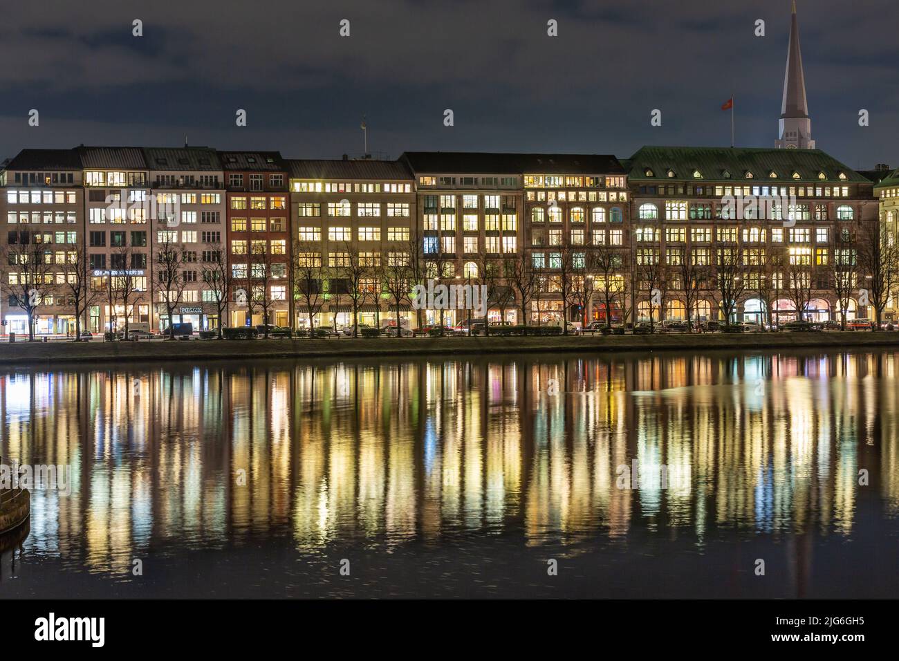the lights of the ballindamm are reflected in the inner alster lake Stock Photo