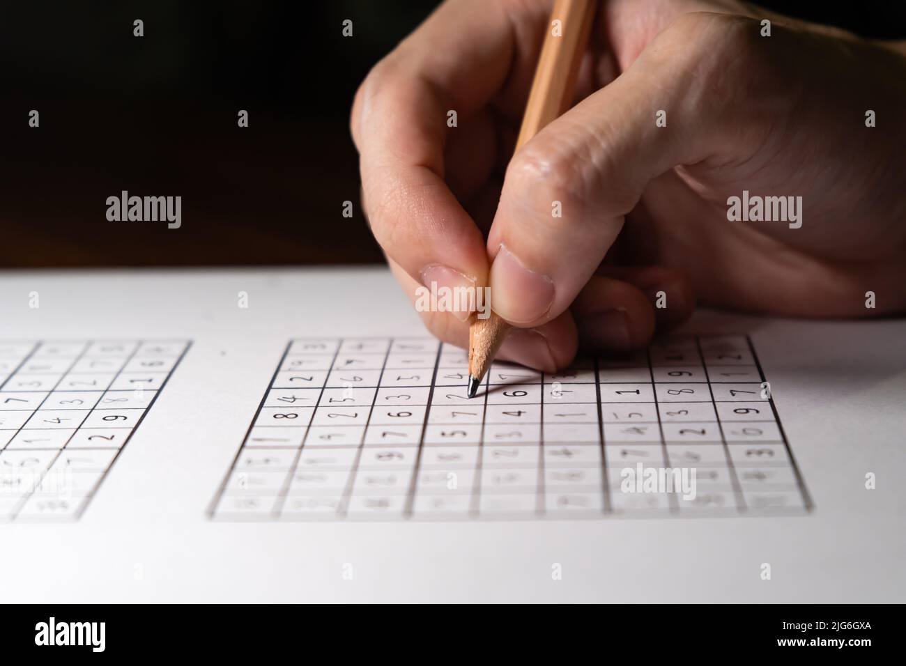 Solving Sudoku puzzle with pencil Stock Photo