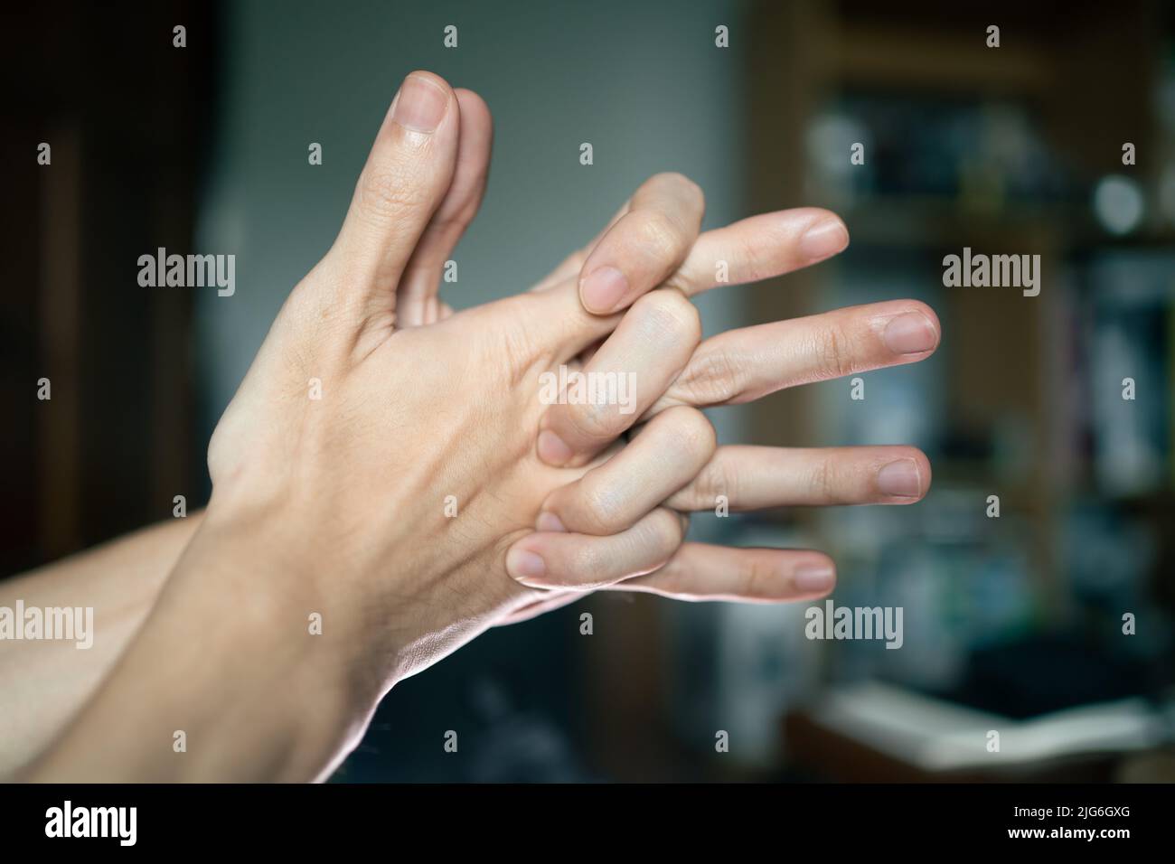 A man doing a knuckle cracking Stock Photo