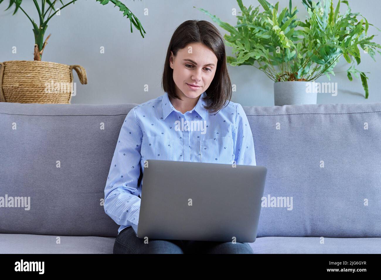 Young woman working from home using laptop Stock Photo - Alamy