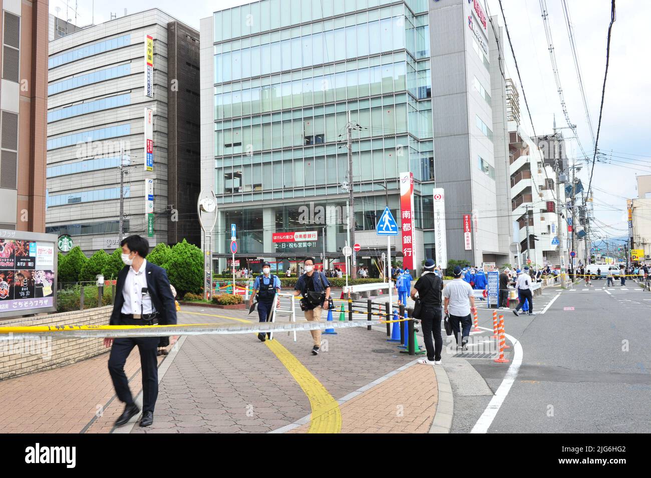 Police officers investigate the scene where Japan's former Prime ...