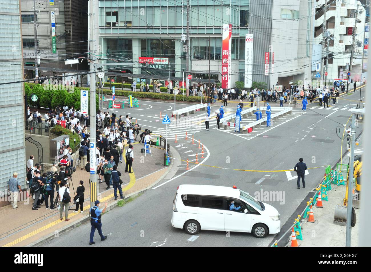Police officers investigate the scene where Japan's former Prime ...