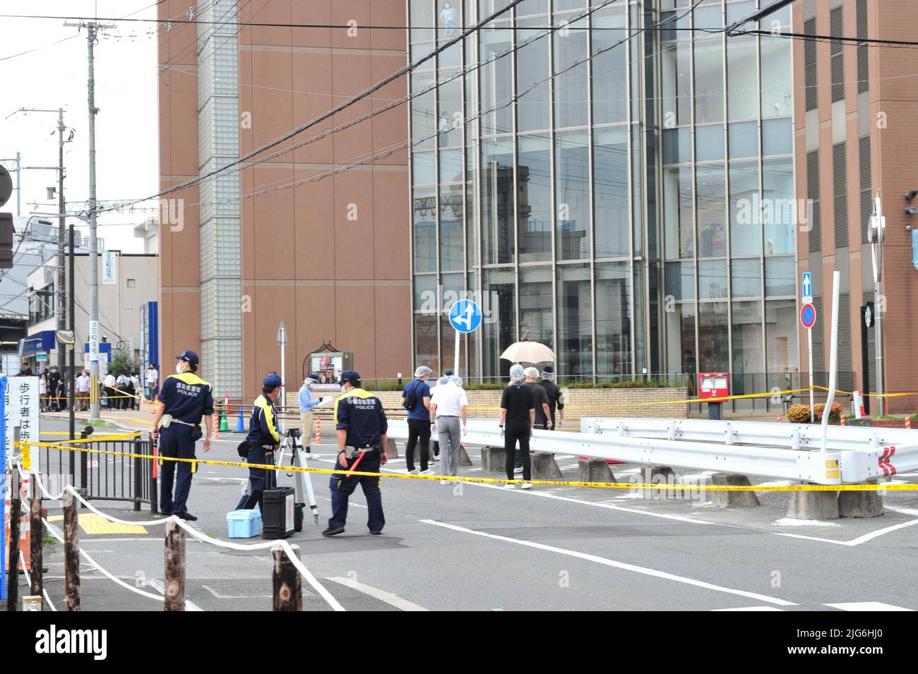 Abe Shot Police officers investigate the scene where Japan's former Prime ...