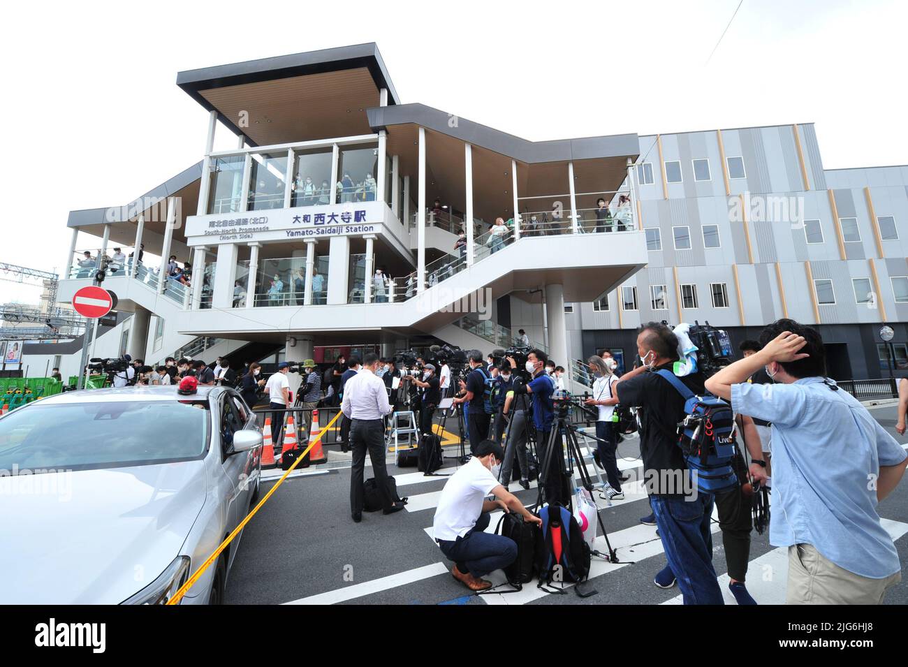 Police officers investigate the scene where Japan's former Prime ...