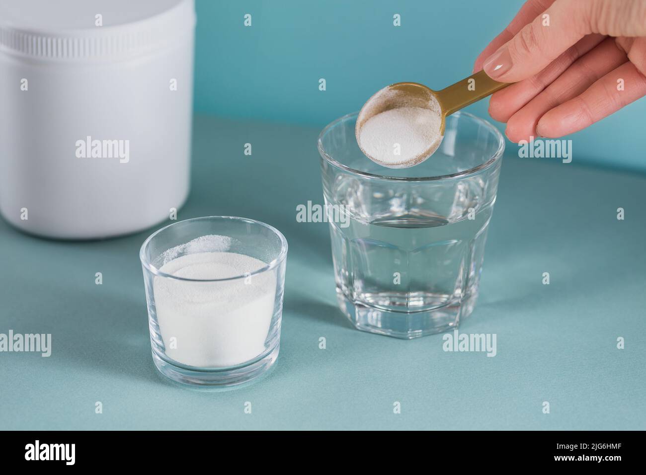 Glass with collagen dissolved in water and collagen protein powder Stock Photo