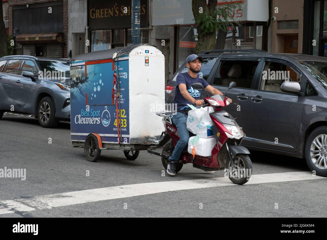 Motorcycle with a portable cupboard closet delivers clean clothes from Best Spot Cleaners on Division St in Williamsburg.  Picture taken on Lee Ave. Stock Photo
