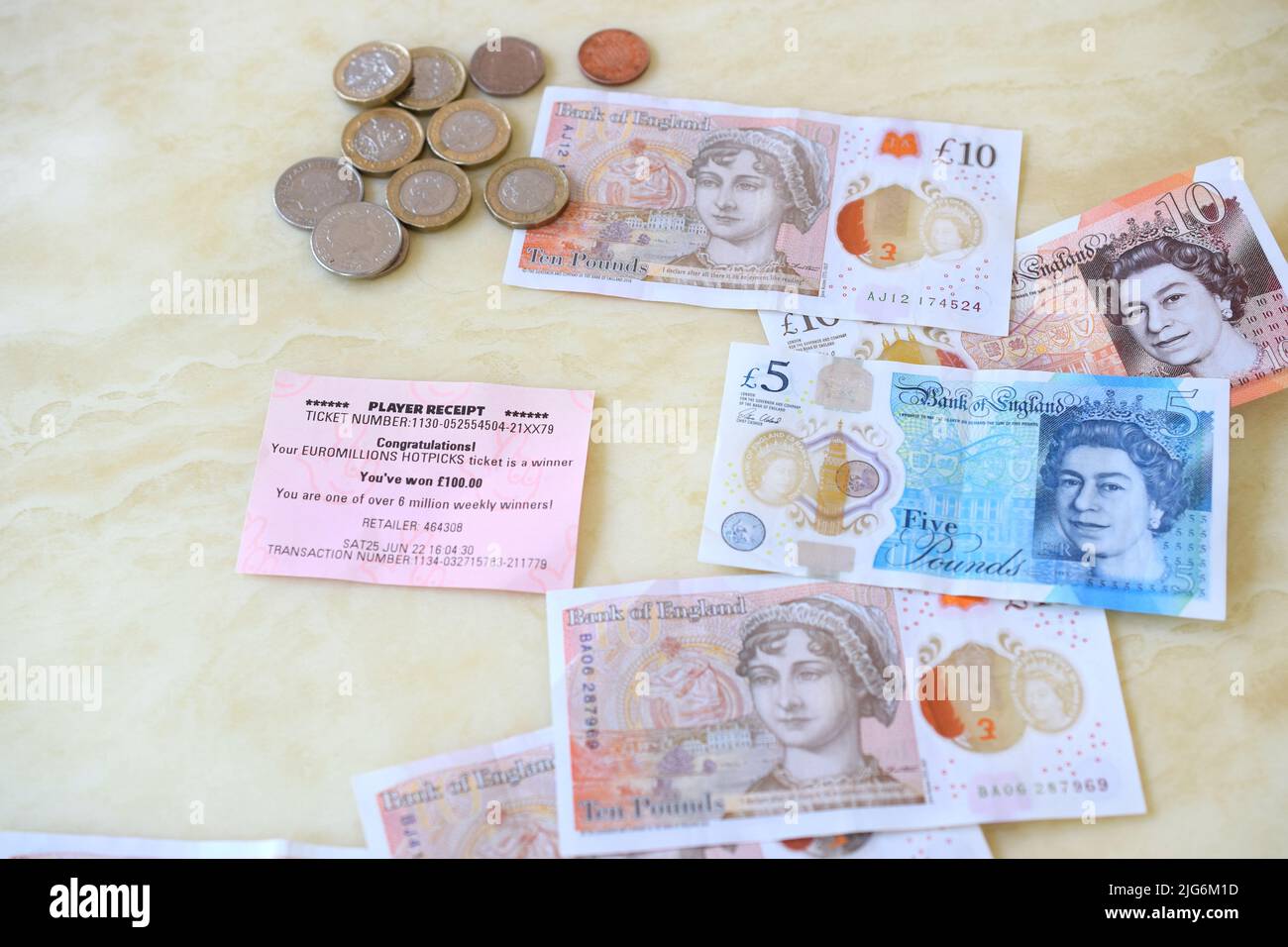 Euromillion hotpicks lottery £100 winning slip and British money. Stock Photo