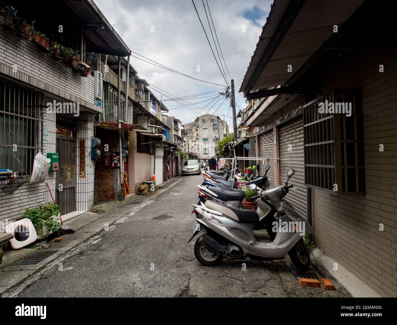 Taipei, Taiwan - Oct,  2016: Narrow side alley with plenty of motors between residential  blocks in New Taipei City. Asia Stock Photo
