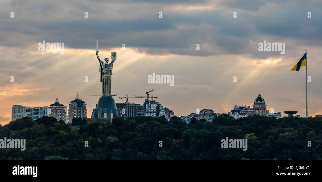 Monument to the Motherland and the Ukrainian flag in Kyiv Stock Photo