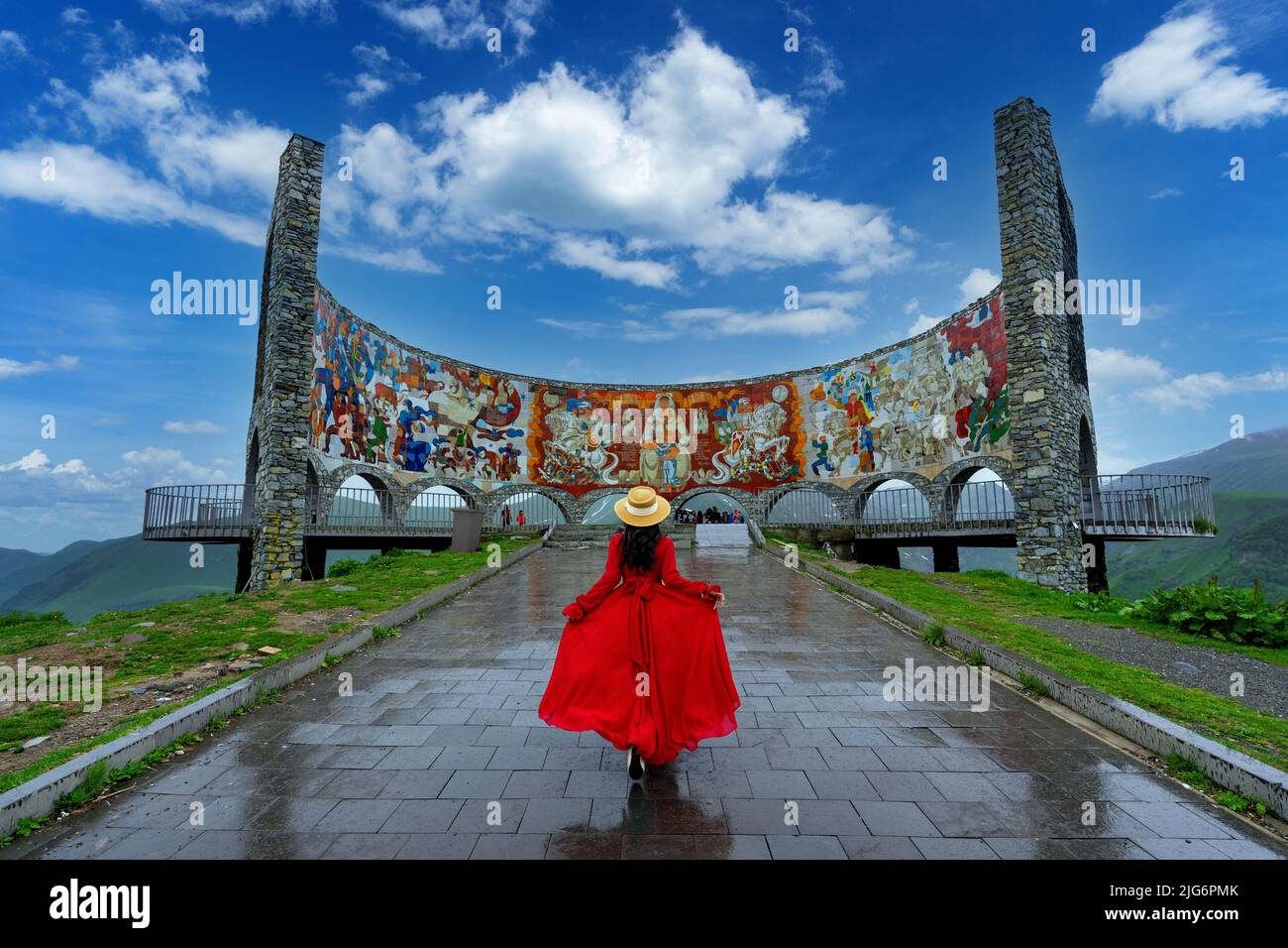 Tourist walking in Russia–Georgia Friendship Monument, Georgia. Stock Photo