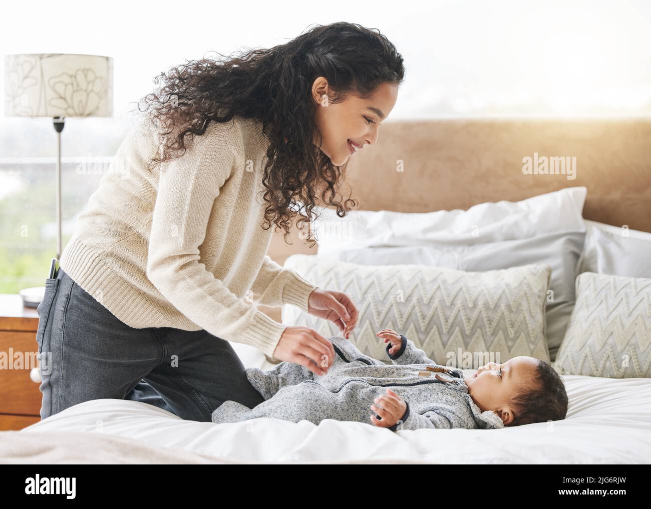 Lets get you into a fresh diaper. Shot of an adorable baby boy and his mother bonding during his diaper change at home. Stock Photo