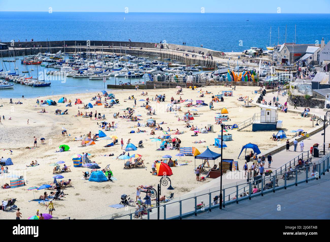 Lyme Regis, Dorset, UK. 8th July, 2022. UK Weather Beachgoers flock to