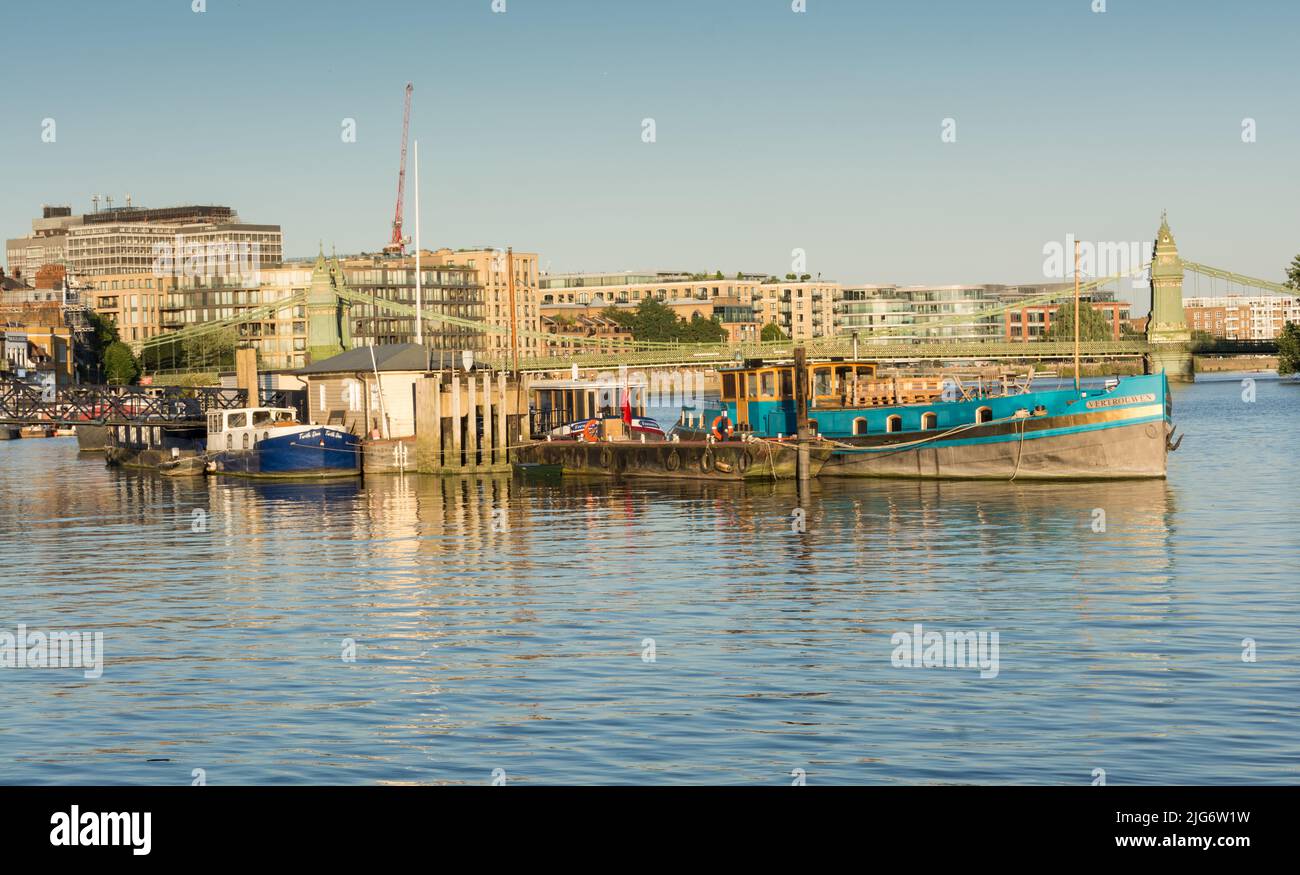 Boats moored at Hammersmith Pier on the River Thames opposite Furnival Gardens, Hammersmith, London, UK Stock Photo