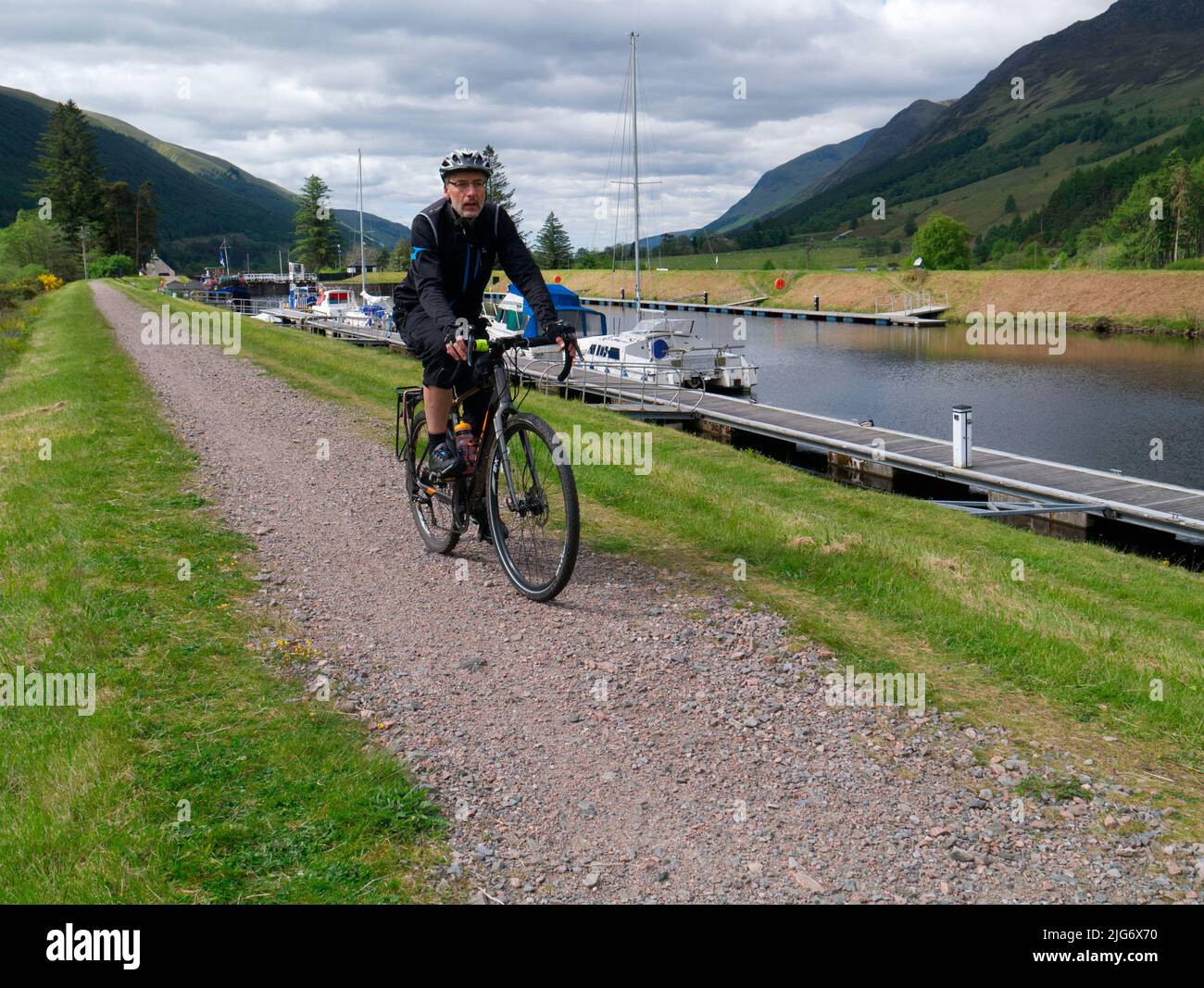 Cycling next to Caledonian Canal at North Laggan, Highland Scotland Stock Photo