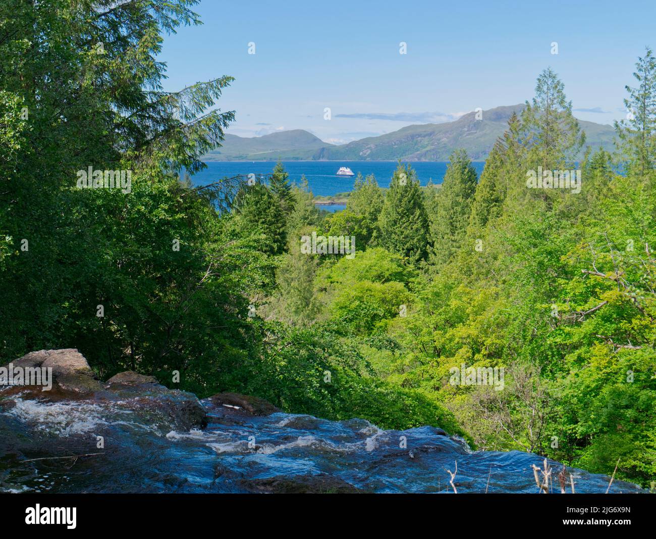 Above Aros waterfall with cruise liner in distance, Isle of Mull Stock Photo