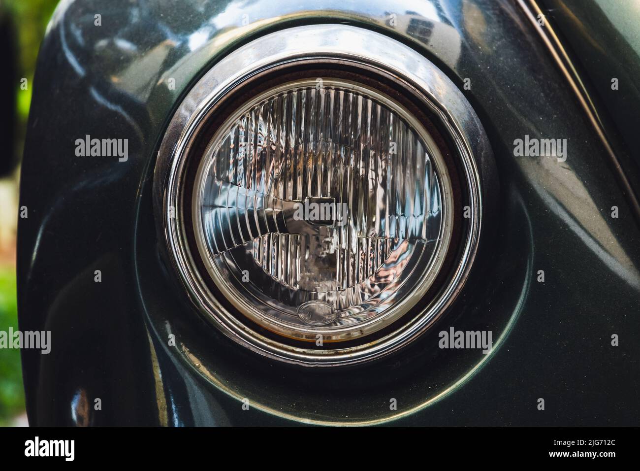 Classic old round headlight. Old timer car details. Close up photo with