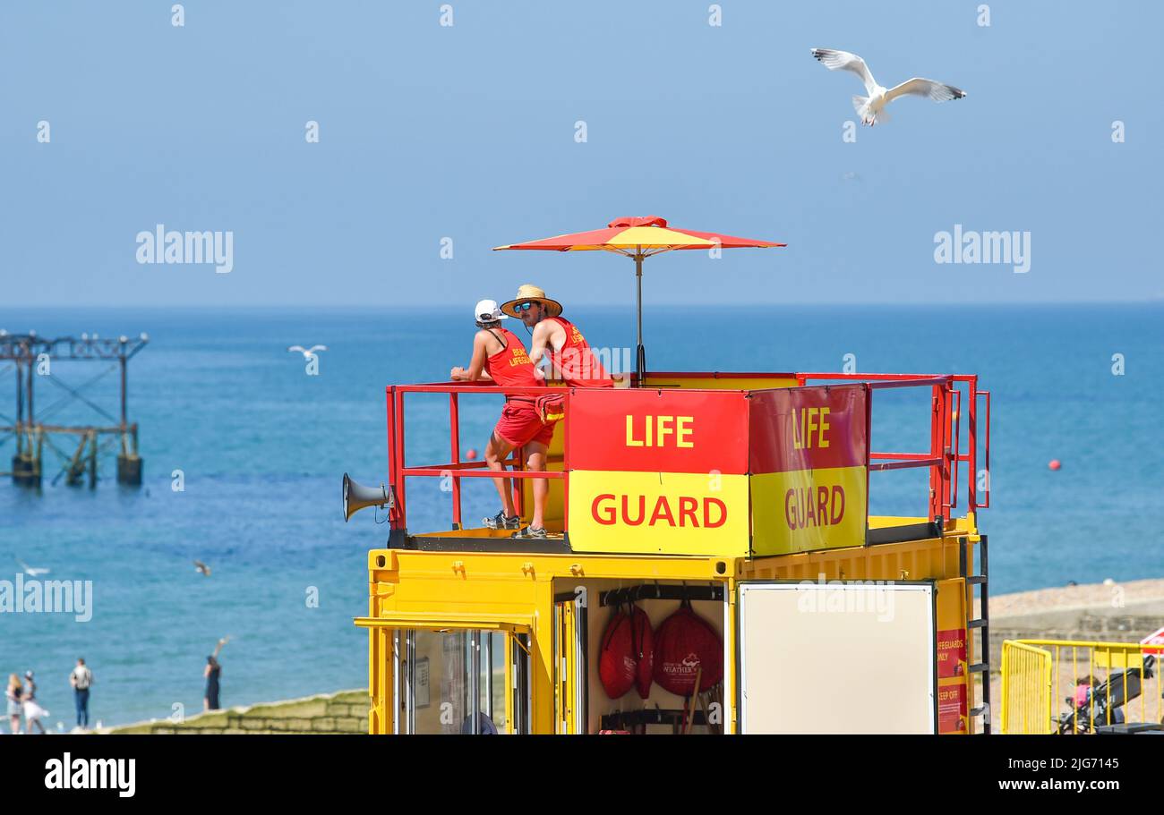 Brighton UK 8th July 2022 - Life guards look out over Brighton beach in the hot sunshine as a possible heatwave is forecast for parts of the UK over the next week .  : Credit Simon Dack / Alamy Live News Stock Photo