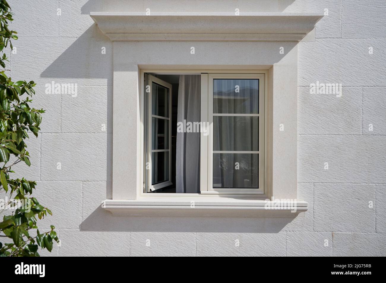 Beige wall with open elegant PVC window. Stock Photo