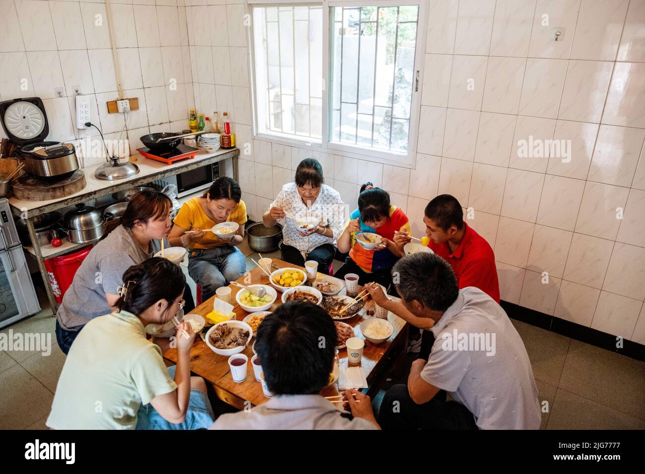 Yunnan, China's Yunnan Province. 20th May, 2022. Cao Liqiong's family has dinner together in Wangjiatan Village of Caopu Township in Anning, southwest China's Yunnan Province, May 20, 2022. TO GO WITH 'Feature: Fostering a spirit of family, homeliness for less fortunate kids' Credit: Cao Mengyao/Xinhua/Alamy Live News Stock Photo