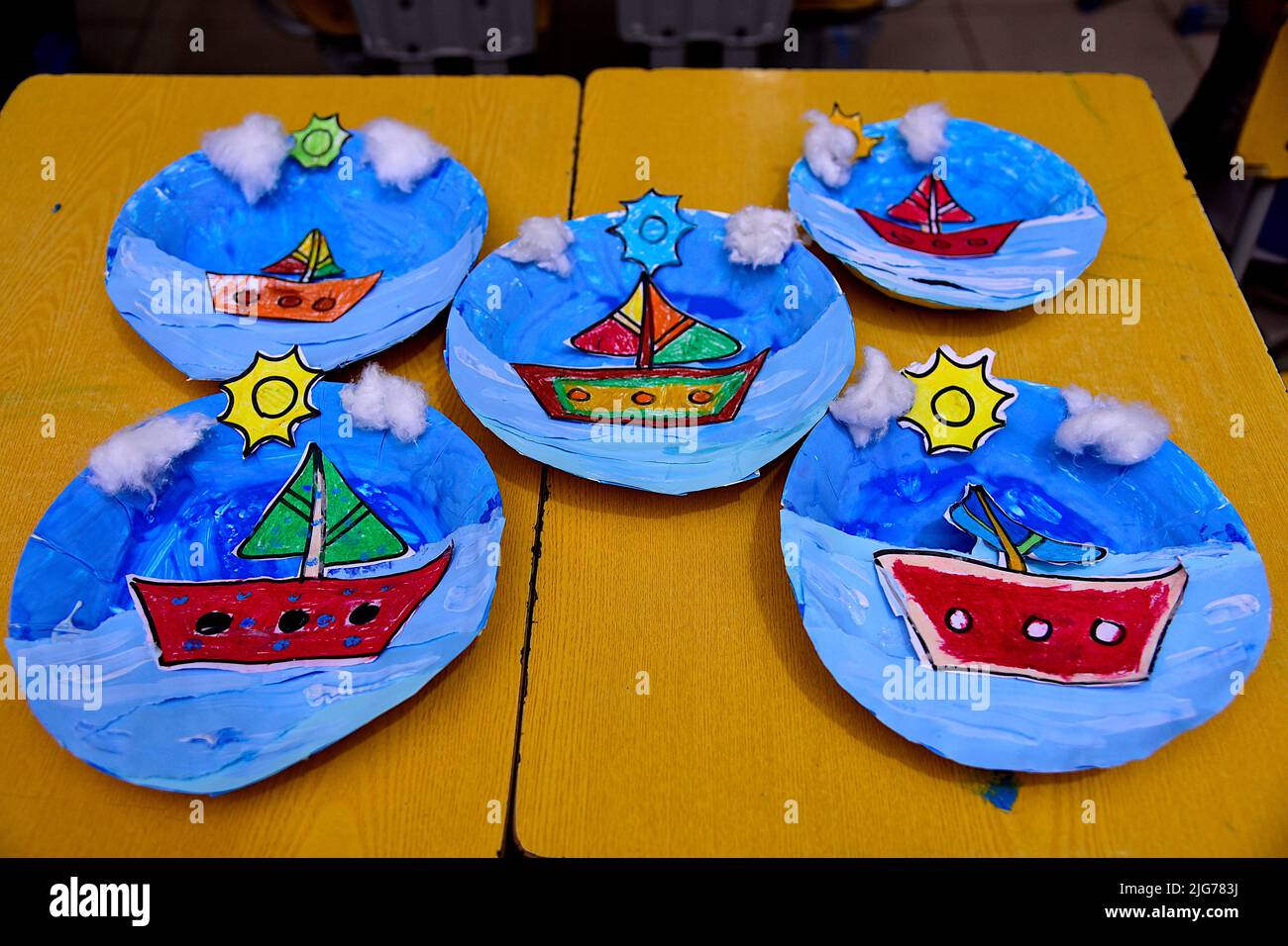 Arts class in Karachi school; paper plate ships Stock Photo Alamy