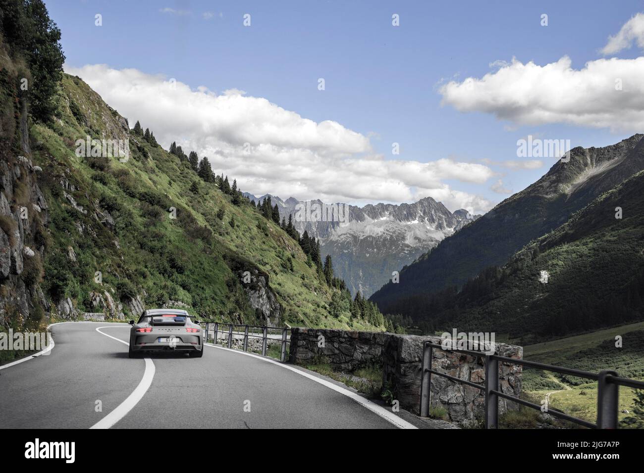 Porsche 911 GT3 sports car on well-built Alpine road from Sustenpass to Wassen, Canton Uri, Switzerland Stock Photo