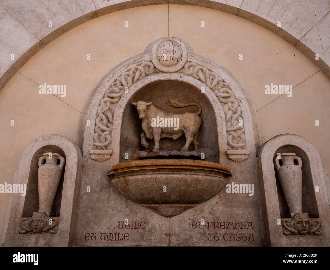 A prominent fountain in the main square of Nardo, Puglia, Italy, with a representation of a bull and 2 vases in a Fascist design from the 1930's Stock Photo