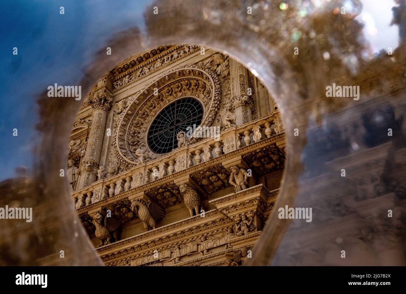 Distorted and abstract view of a Baroque Catholic Church and its rose window along with animal and Saracens holding up the facade Stock Photo