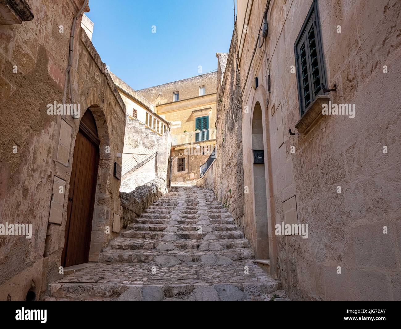 Street scene in the Sassi neighborhood of Matera, Italy with limestone houses and cave-like dwellings throughout & dating from Paleolithic times Stock Photo