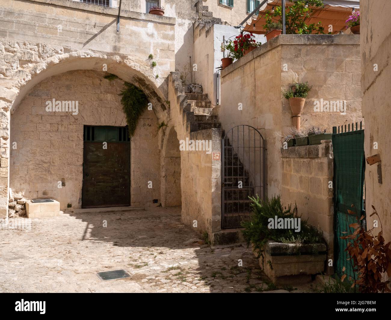 Street scene in the Sassi neighborhood of Matera, Italy with limestone houses and cave-like dwellings throughout & dating from Paleolithic times Stock Photo
