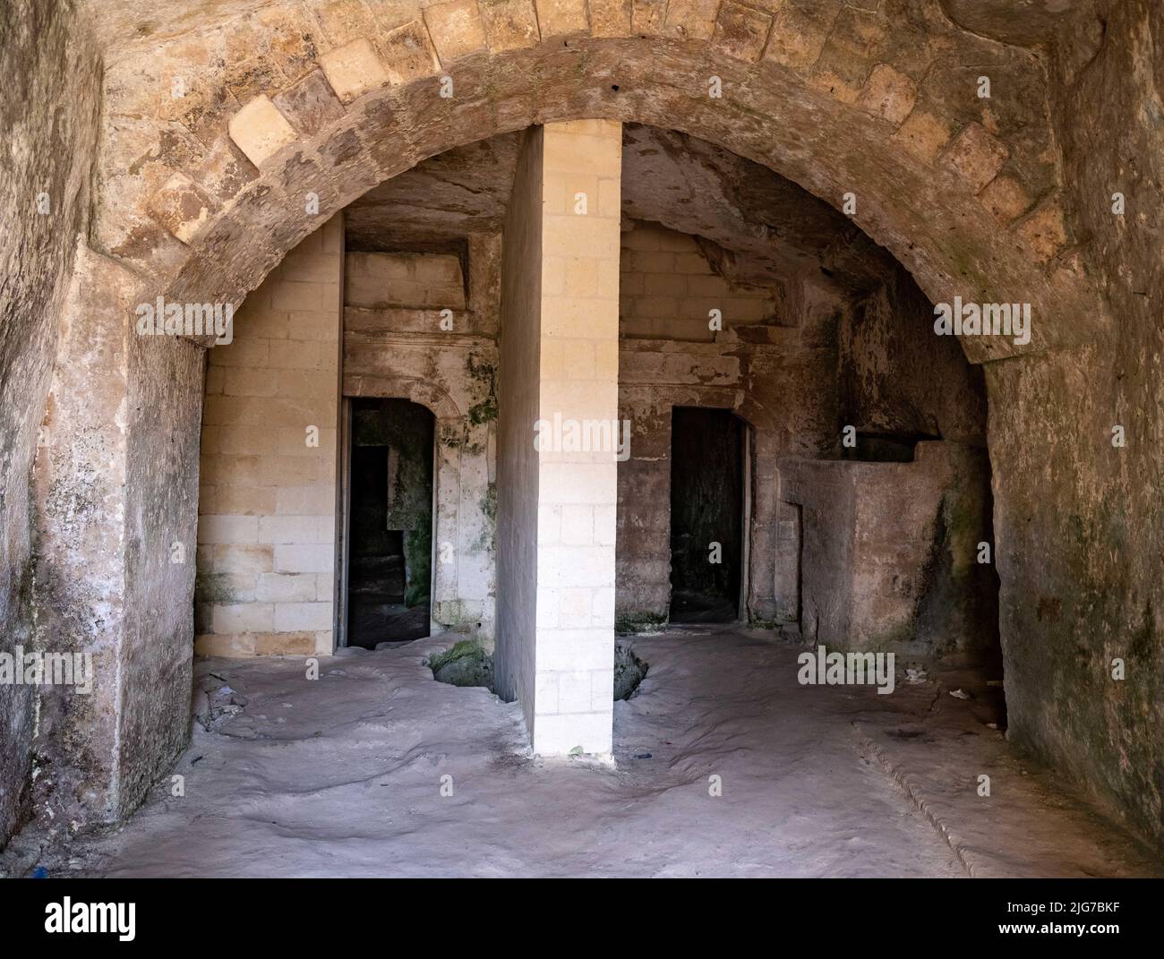 Unrestored cave dwelling of the Sassi in the ancient Italian town of Matera, Basilicata with various rooms, arches, and cisterns Stock Photo