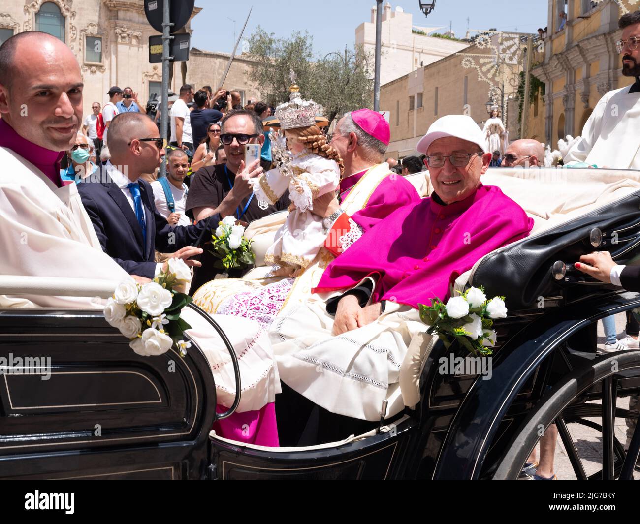 An Archbishop and Bishop of the Matera region driven in a carriage during the procession of the Brown Madonna, an annual rite of the city Stock Photo