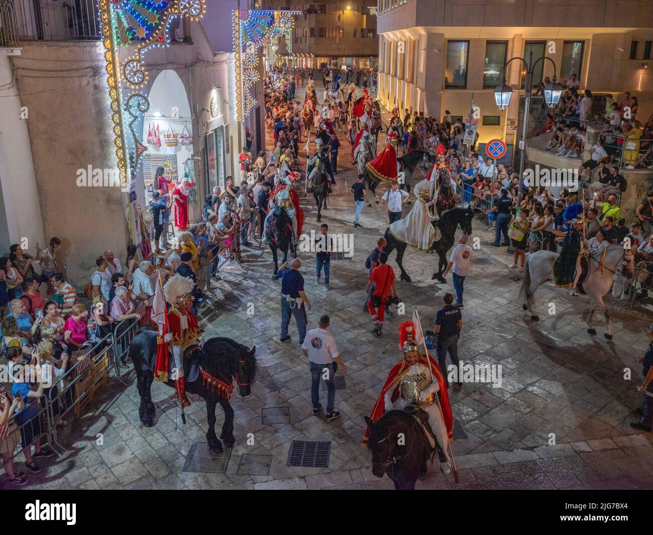 Procession for the celebration of the festival of the Brown Madonna of Matera with men on horseback in traditional garb leading the festivities Stock Photo